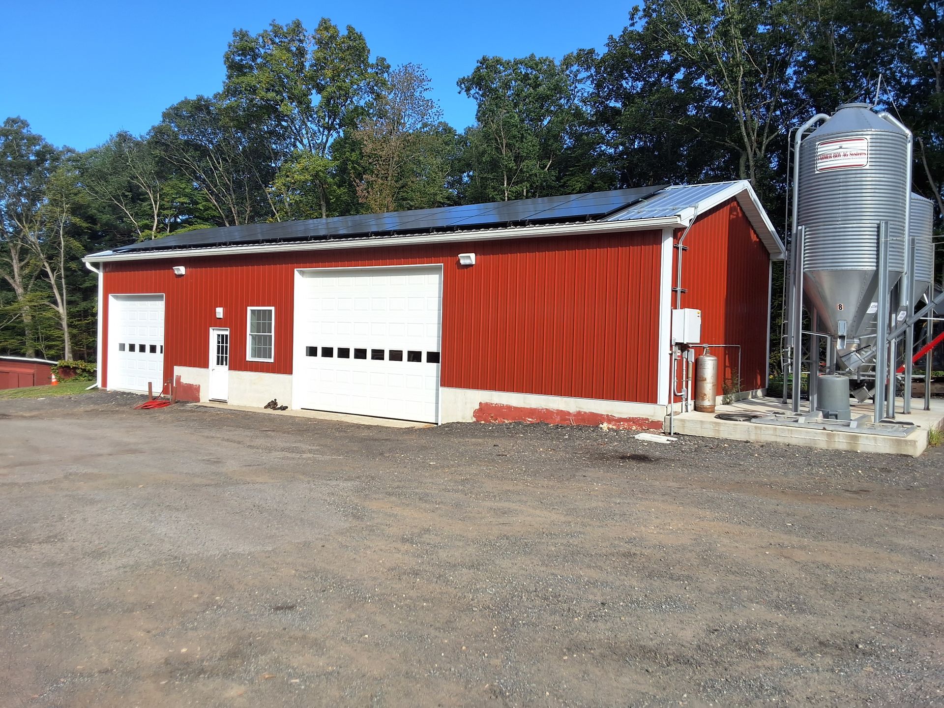 A red barn with solar panels on the roof