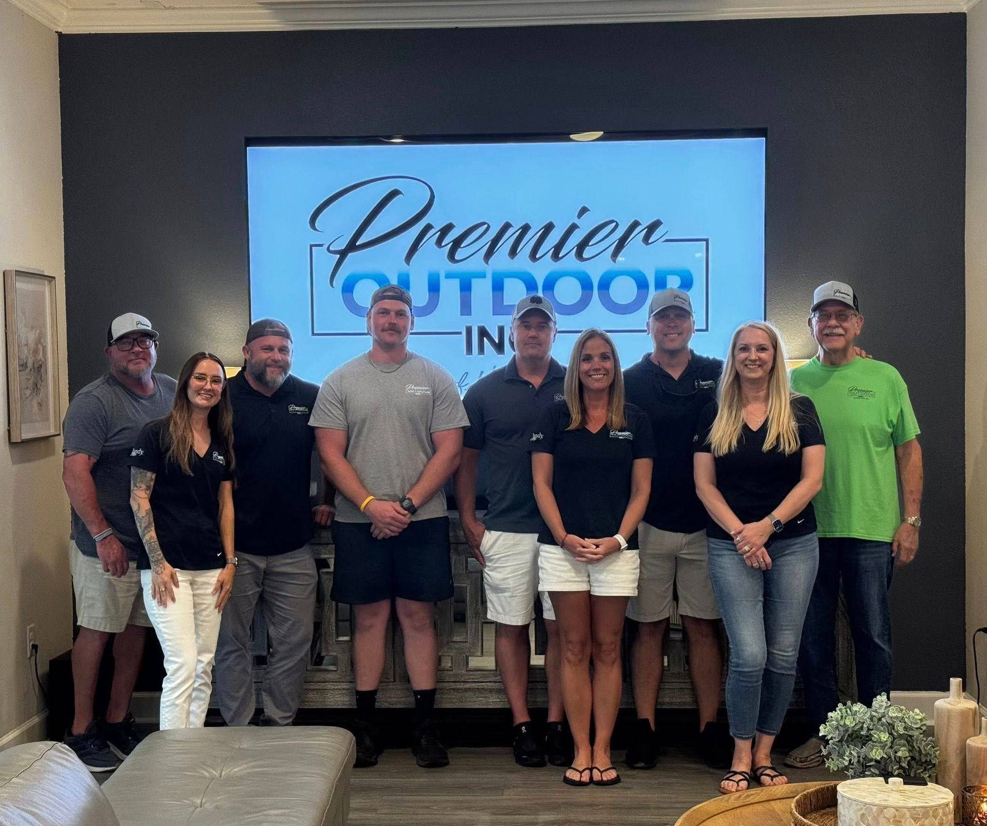 Group of people posing in front of a screen with 