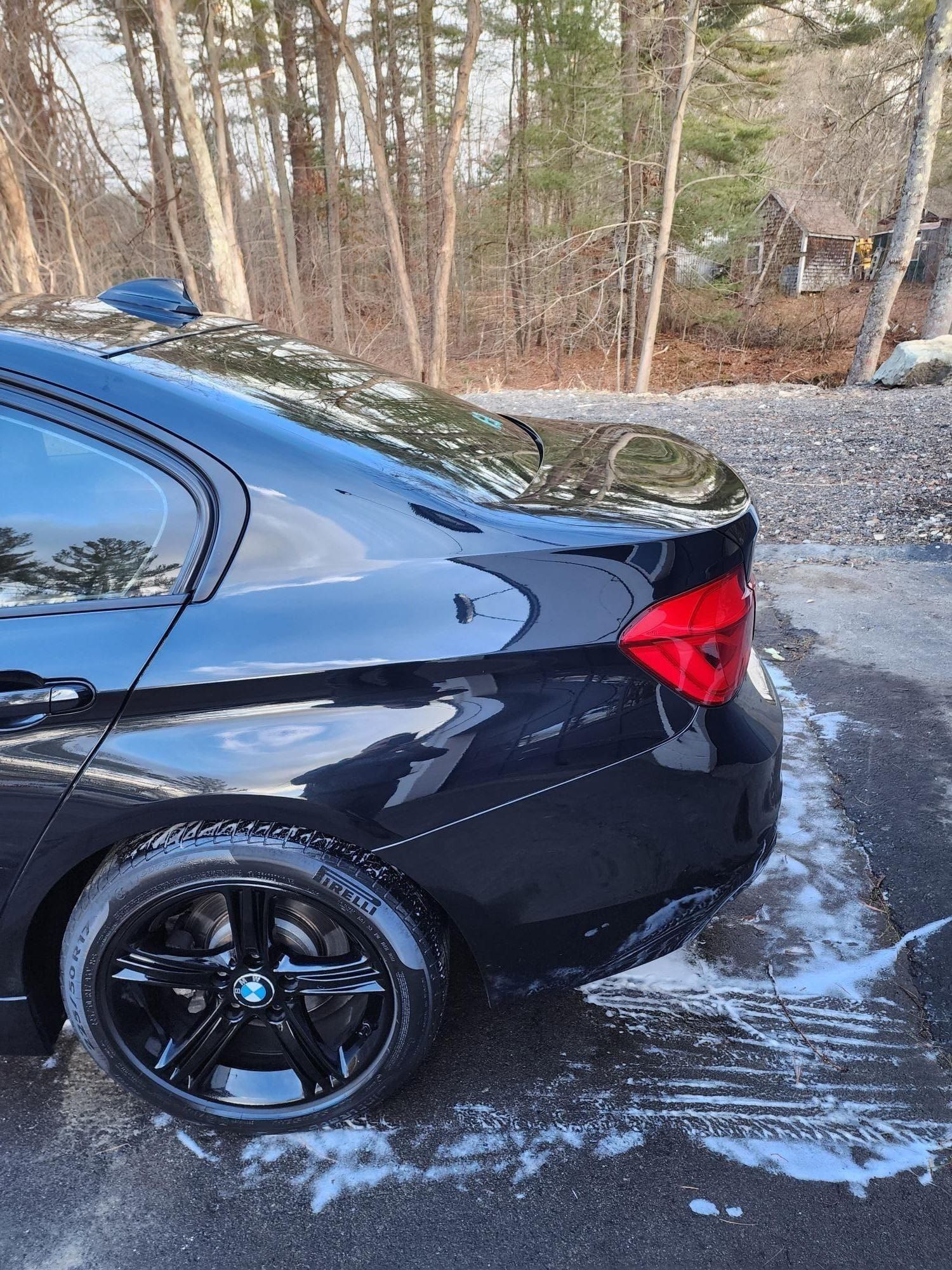Black BMW car parked outside with suds.