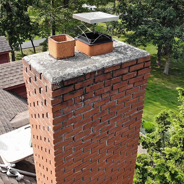 An aerial view of a brick chimney on top of a roof.