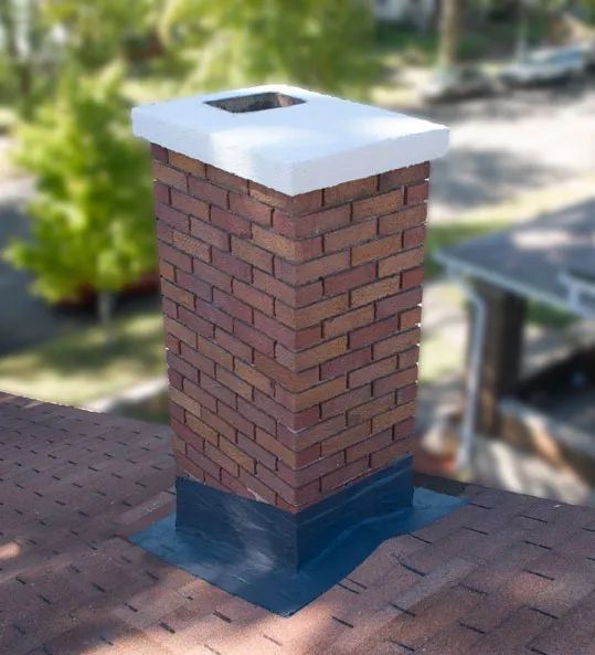 A brick chimney sitting on top of a roof