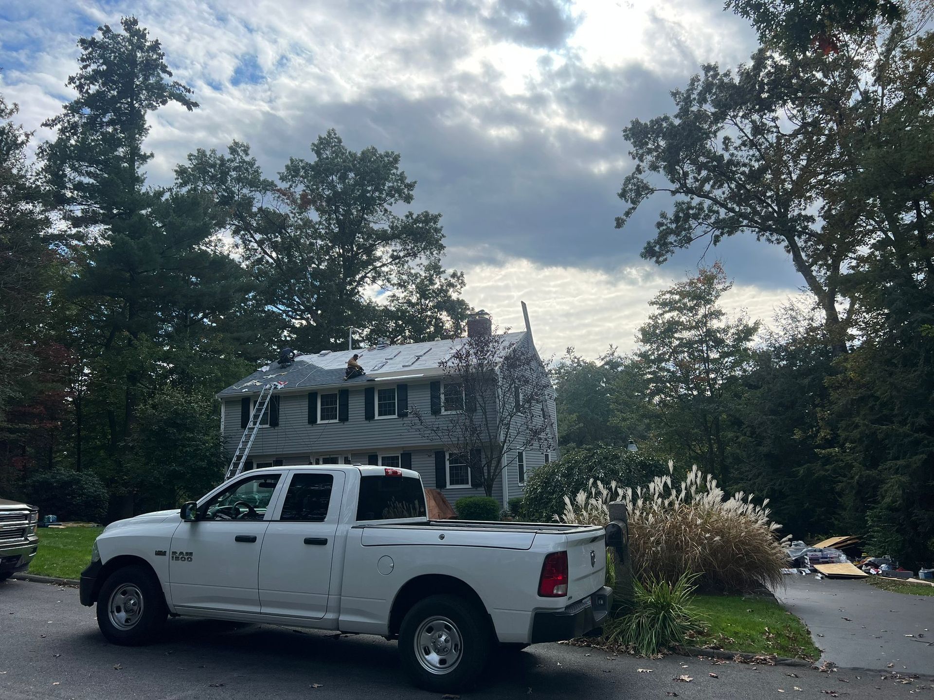 A white truck is parked in front of a house.