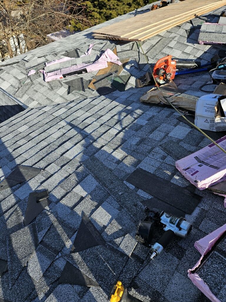 A roof is being repaired with a lot of tools on it.