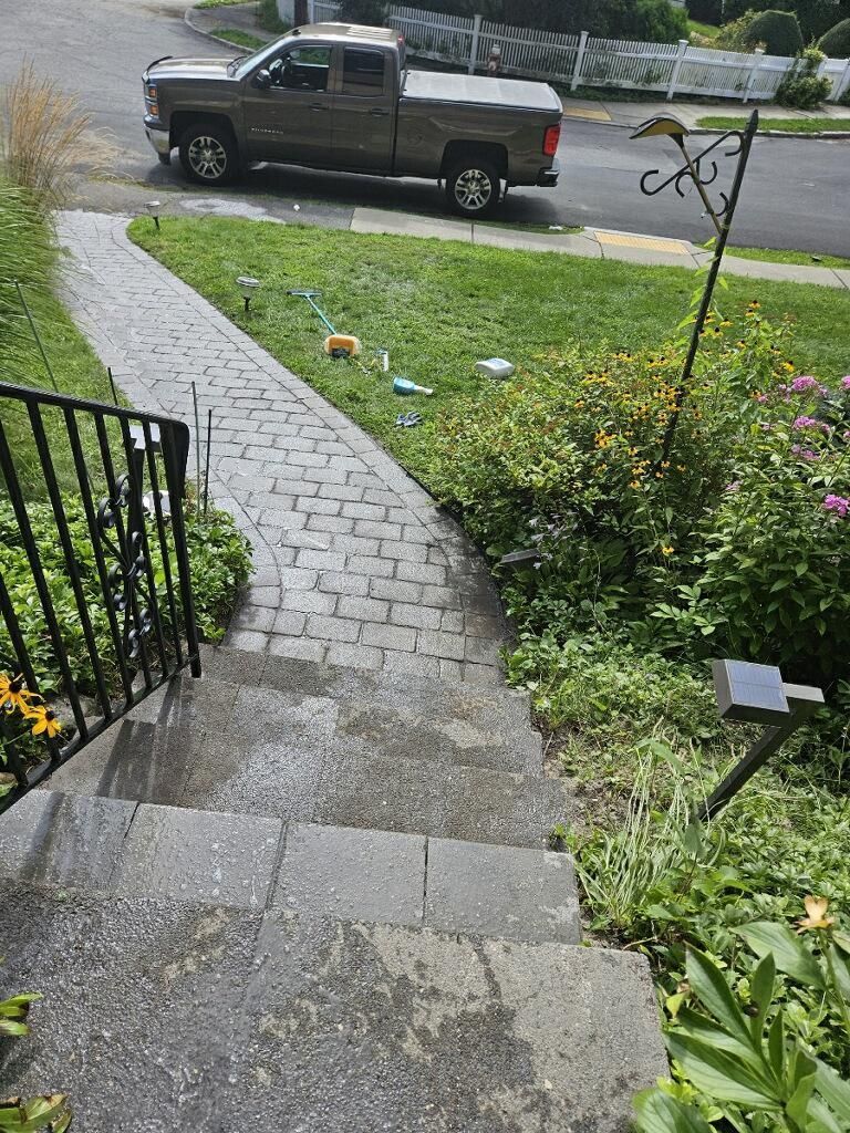 A truck is parked on the side of the road next to a sidewalk.