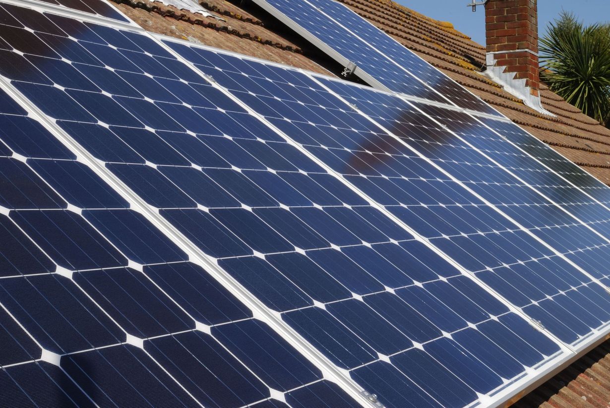 A row of solar panels on the roof of a house