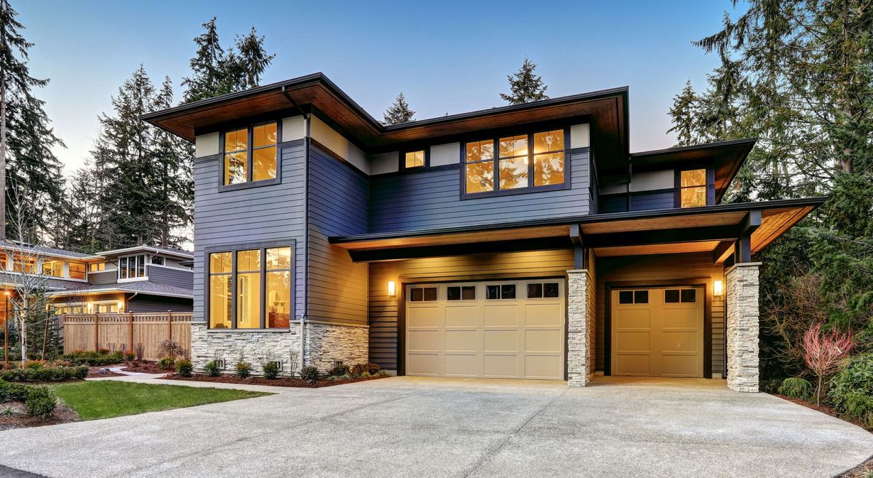 A large house with a garage and a driveway in front of it.