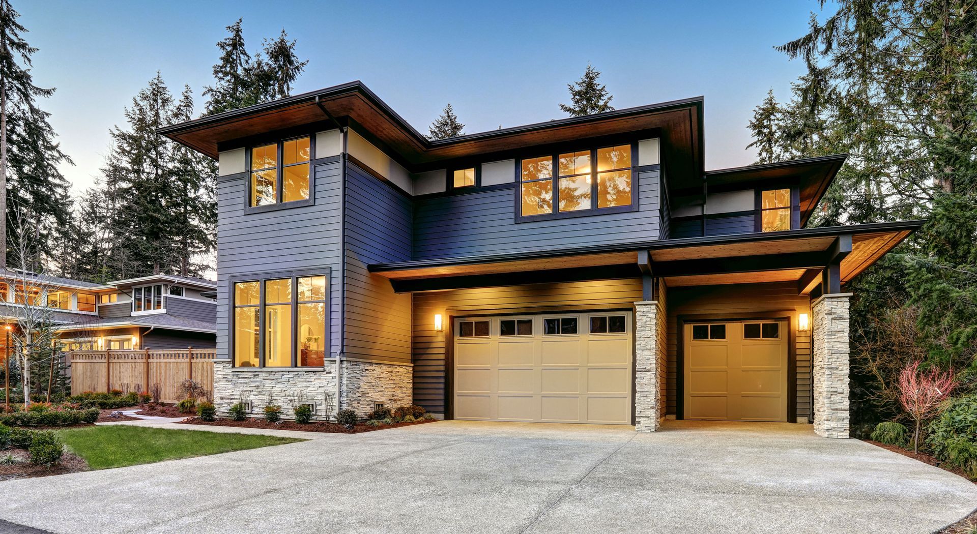 A large house with a garage and a driveway in front of it.