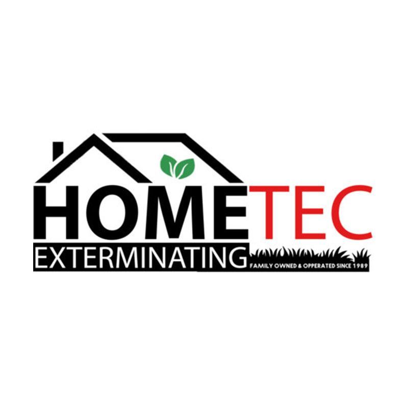 Man with short brown hair, smiling, wearing a light blue button-down shirt.