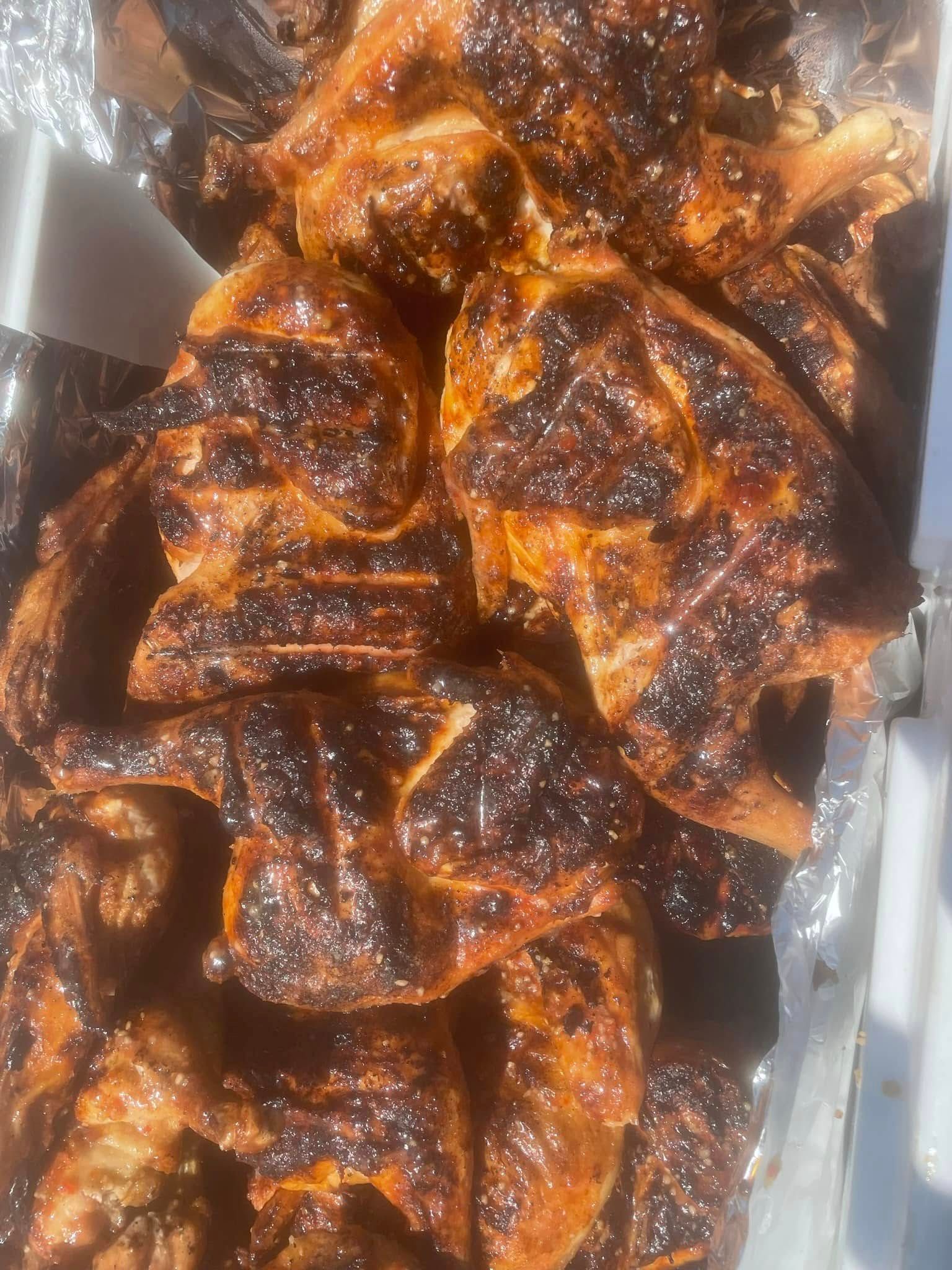 A close up of a pile of grilled meat on a tray.