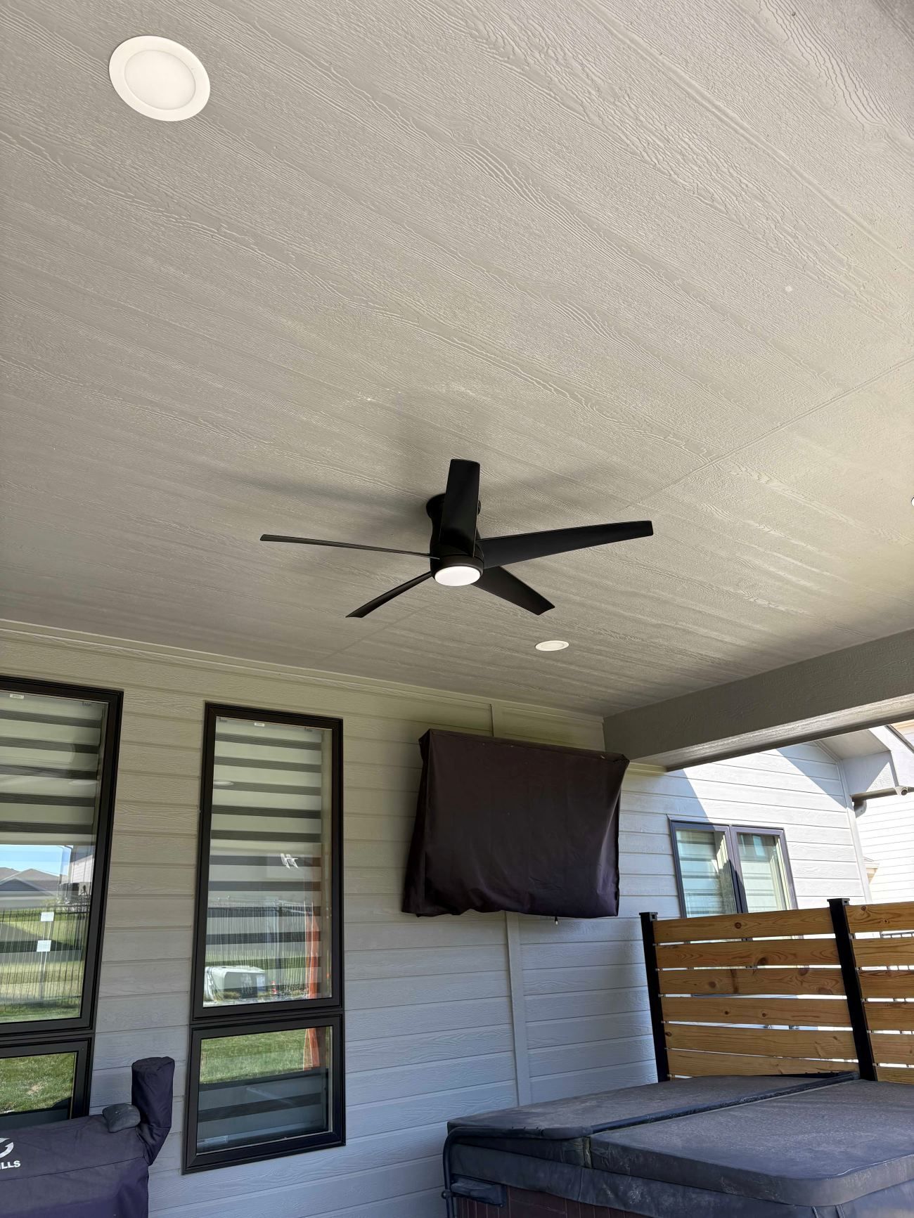 A ceiling fan is hanging from the ceiling of a house.