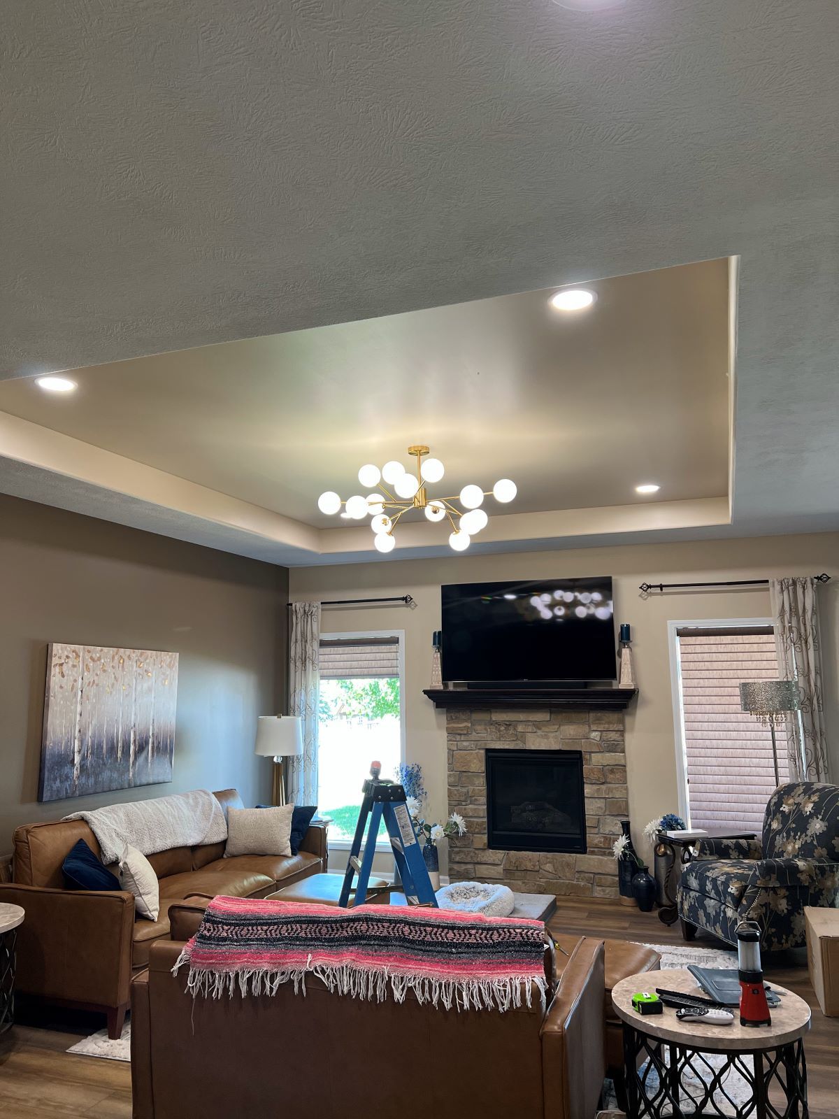 A living room with a fireplace , couch , and television.