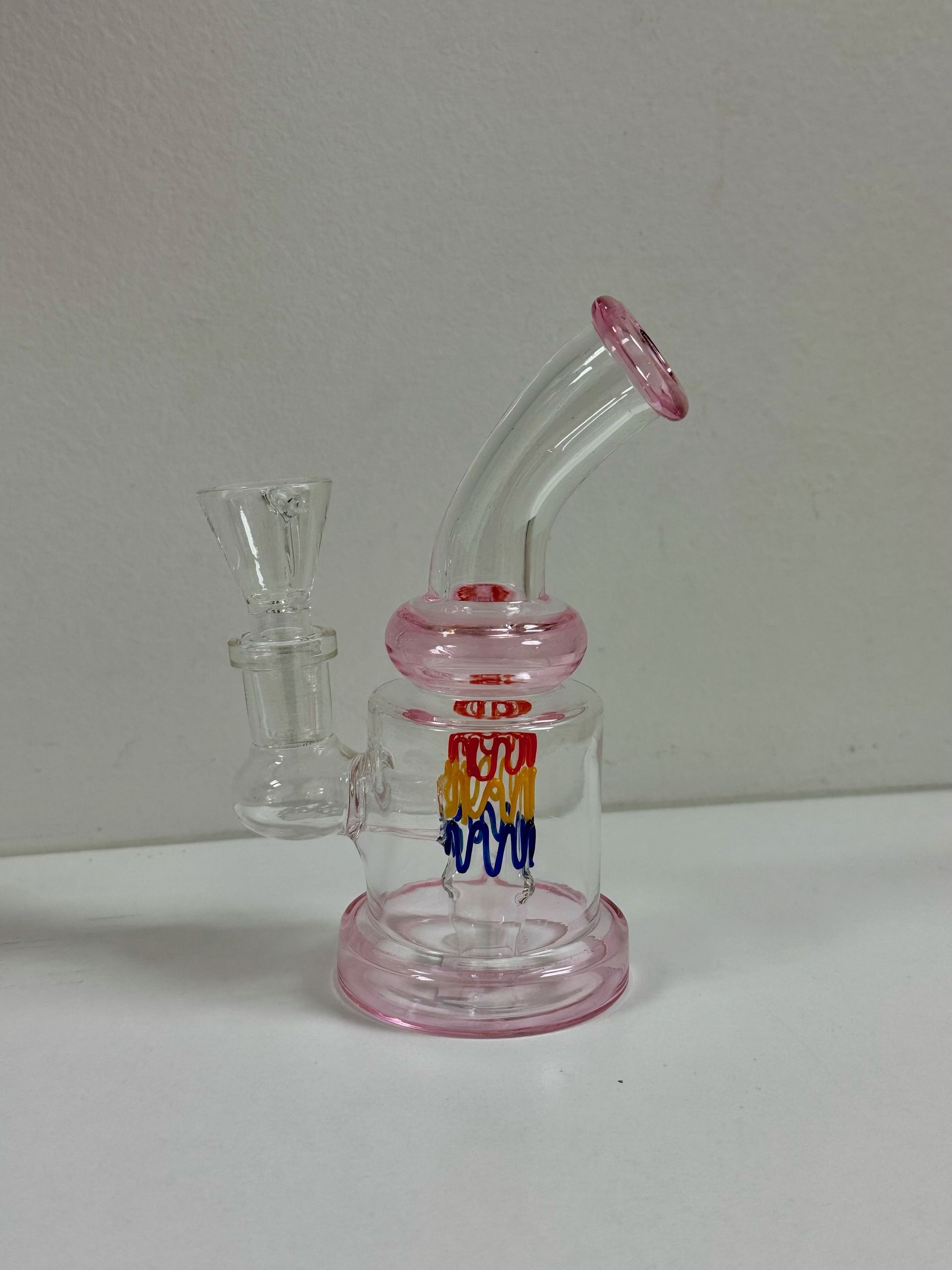 A pink glass pipe with the word popcorn on it