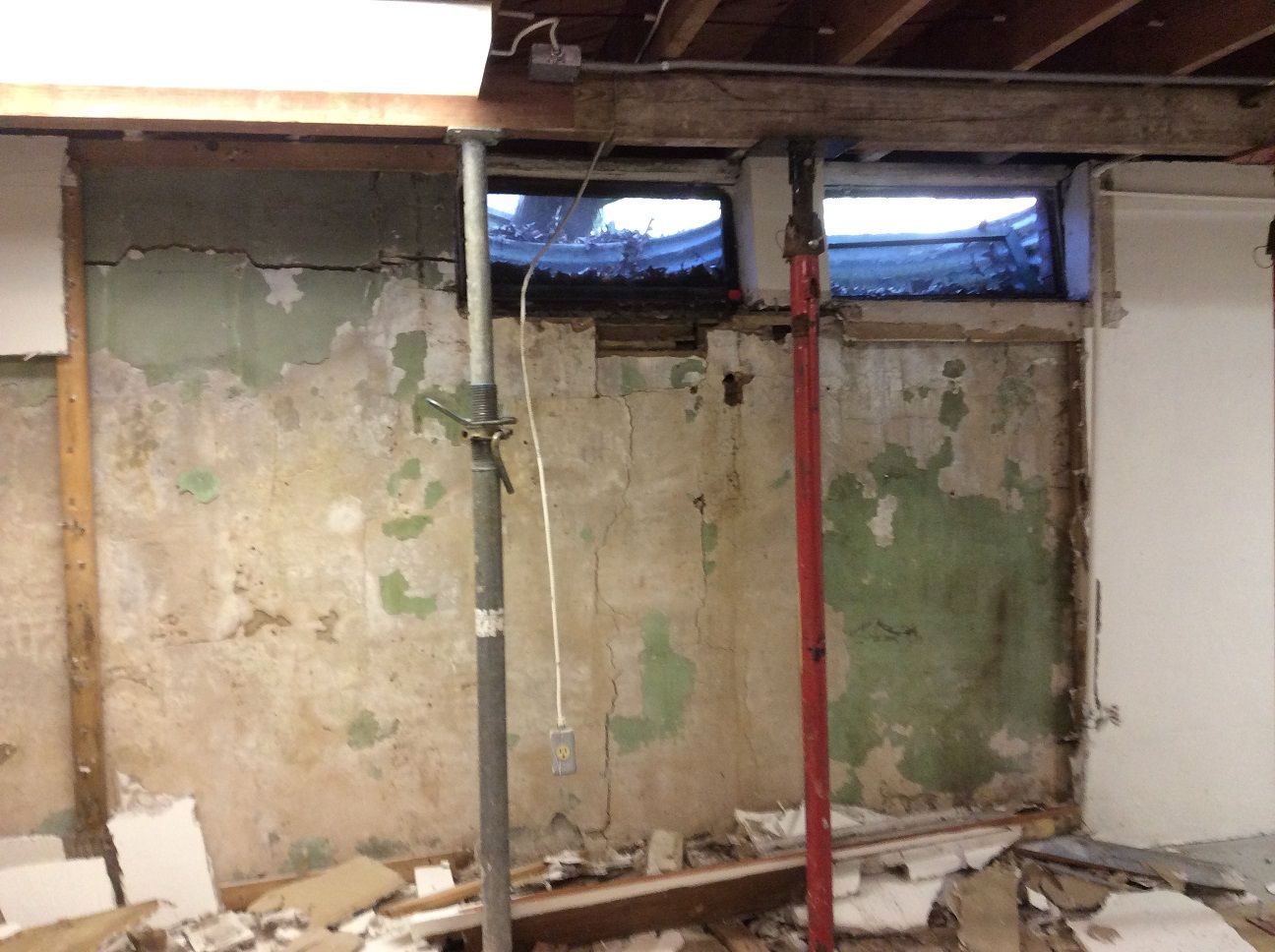 A room with a green wall and a red pole