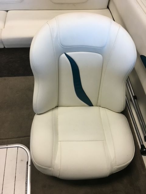 A white boat seat with a blue stripe on the back