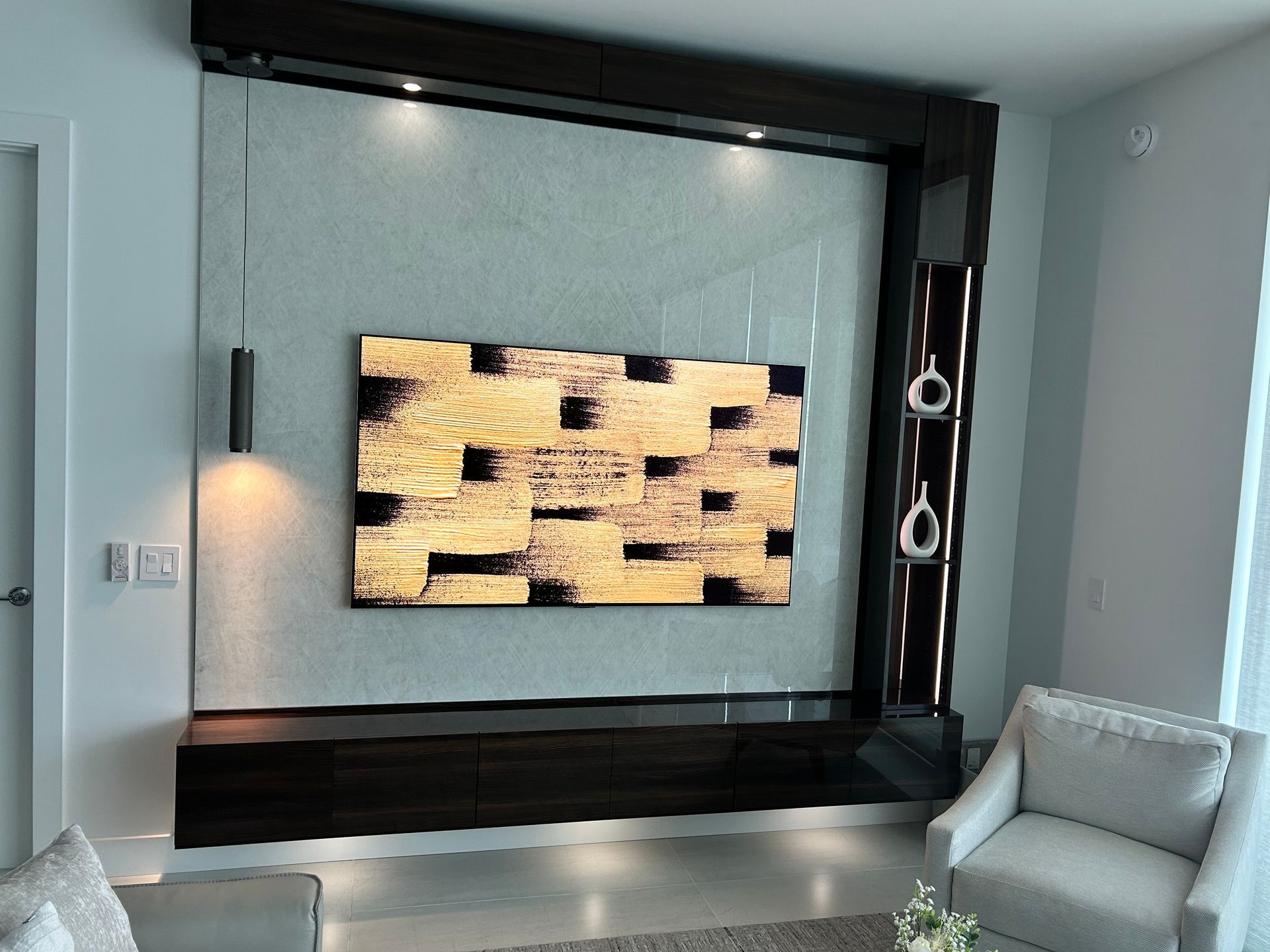 A living room with a flat screen tv hanging on the wall.