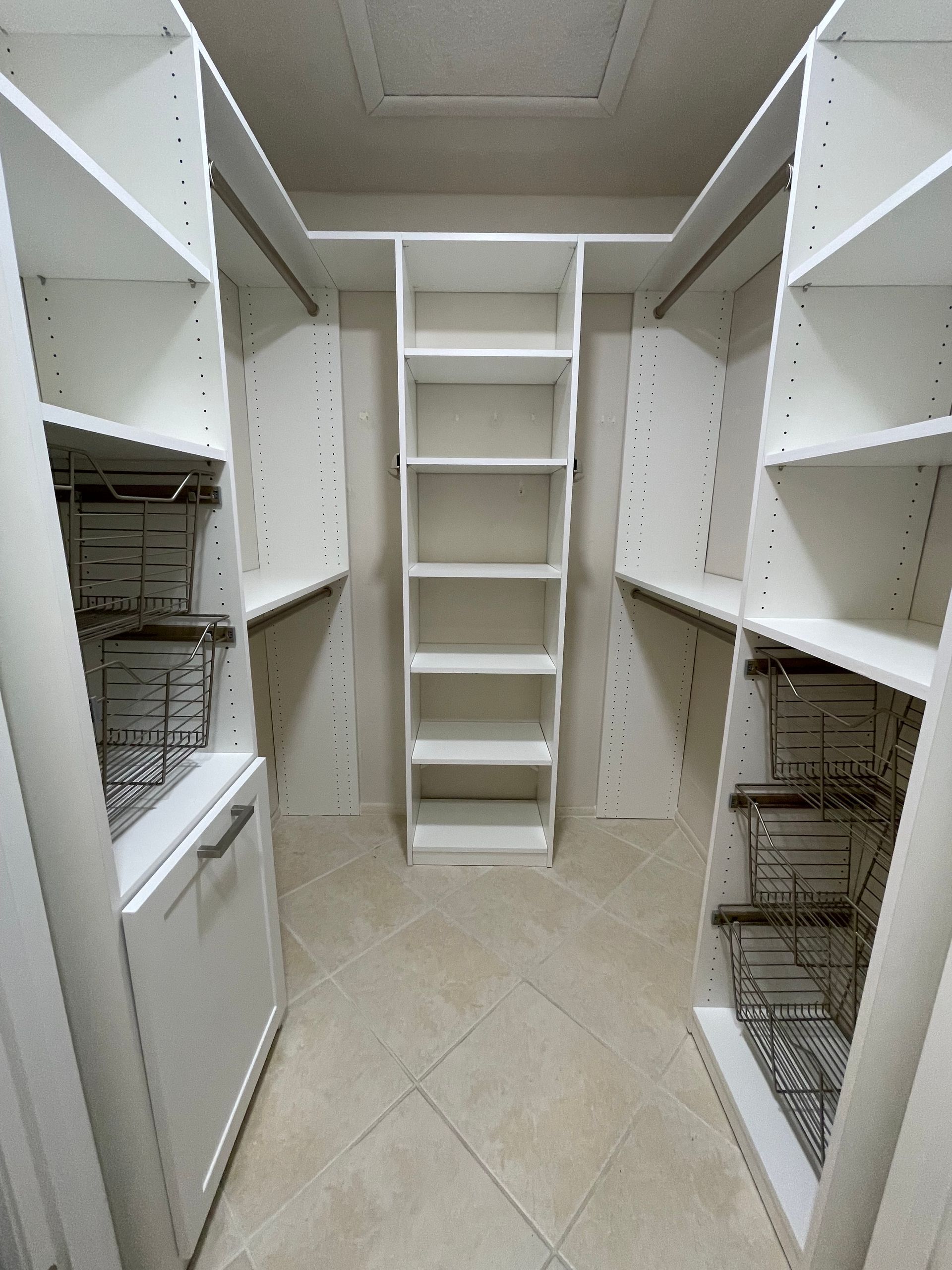 A walk in closet with lots of shelves and baskets