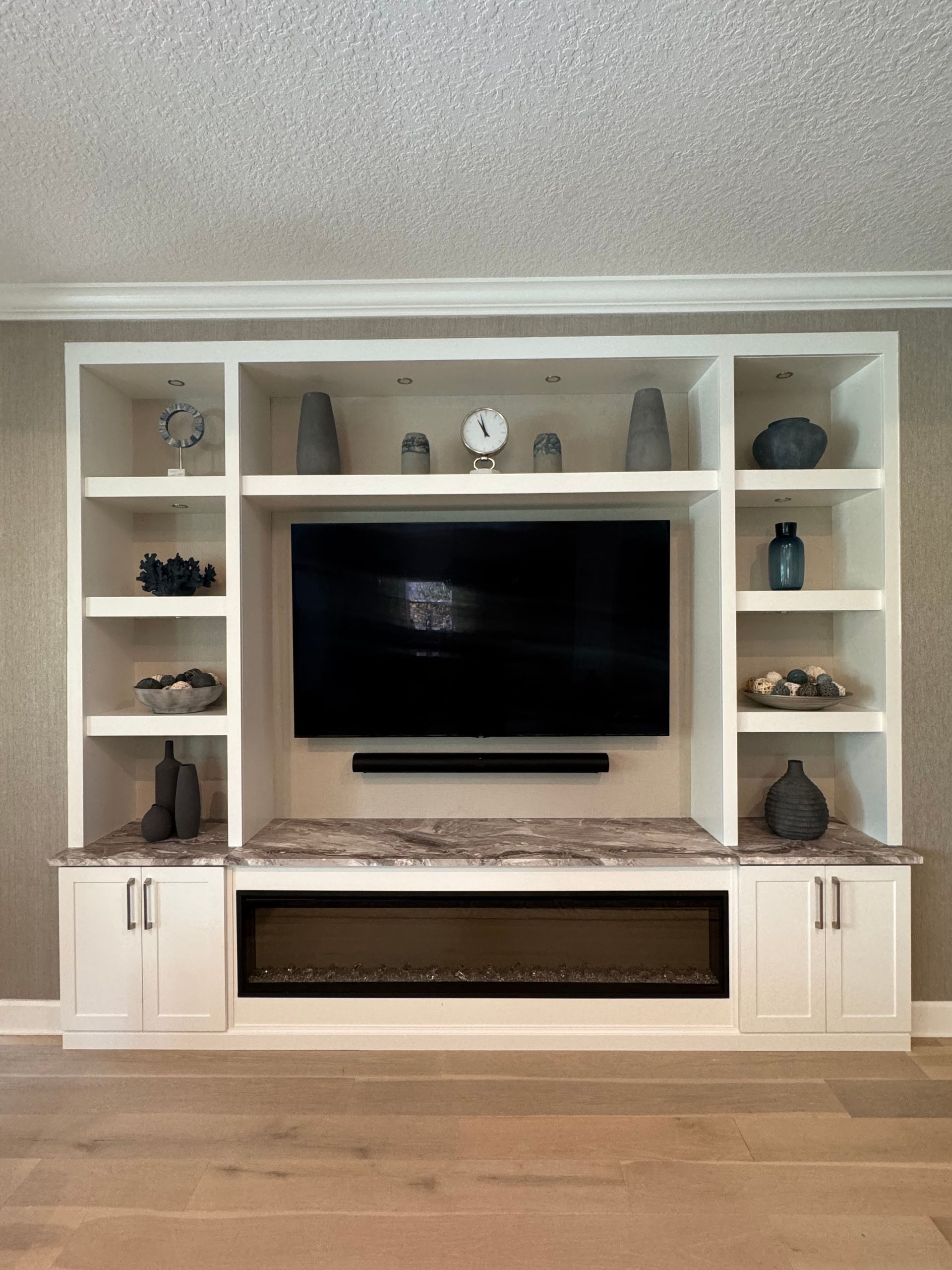 A living room with a fireplace and a flat screen tv