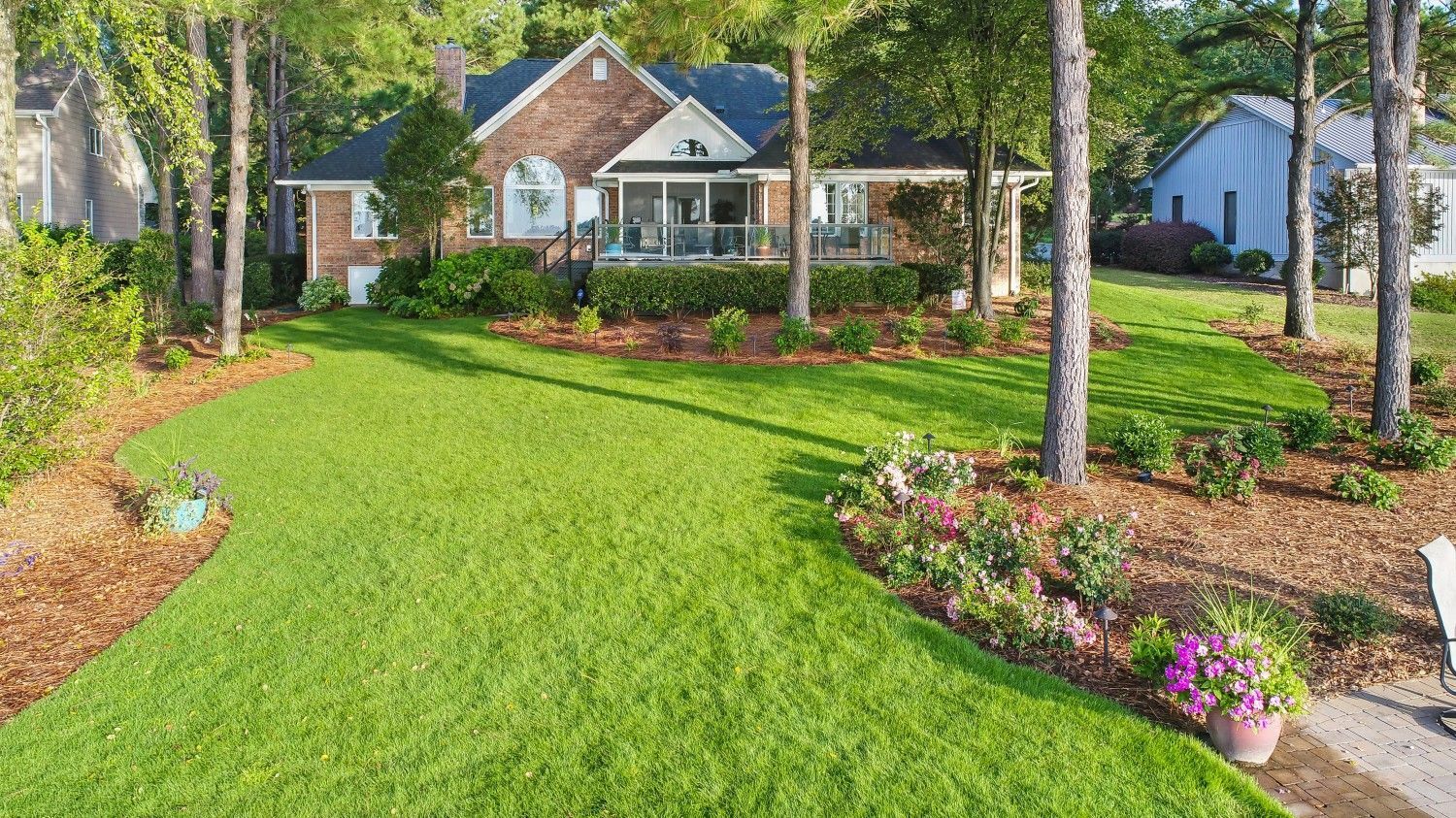 A view of a lush green lawn in front of a house