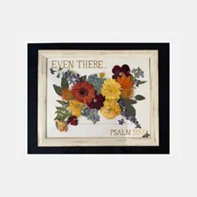 Framed artwork with dried flowers and text 