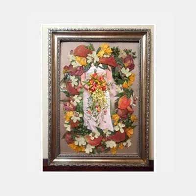 Floral artwork of a figure holding a bouquet, surrounded by flowers, within a framed setting.