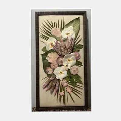 Floral art in a dark wooden frame. White orchids, pink flowers, green leaves on a light background.