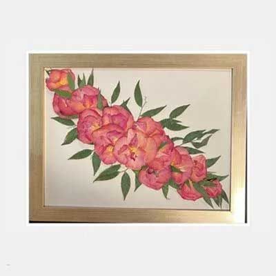 Pink floral arrangement in a gold frame.