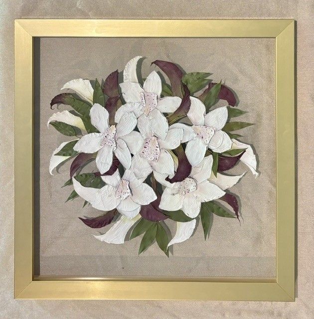 Framed floral artwork with white and burgundy flowers and green leaves on a beige background.