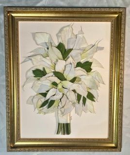 Framed floral painting of a white lily bouquet with green leaves in a vase.