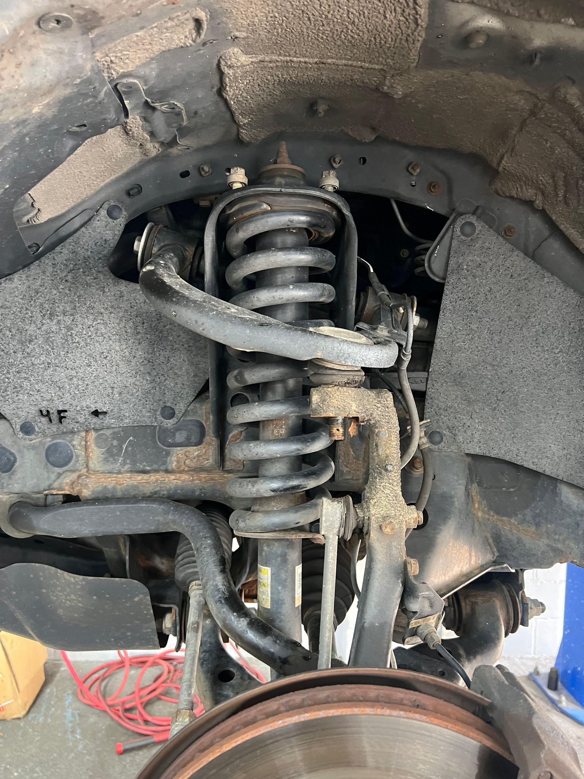 A close up of a shock absorber on a car.