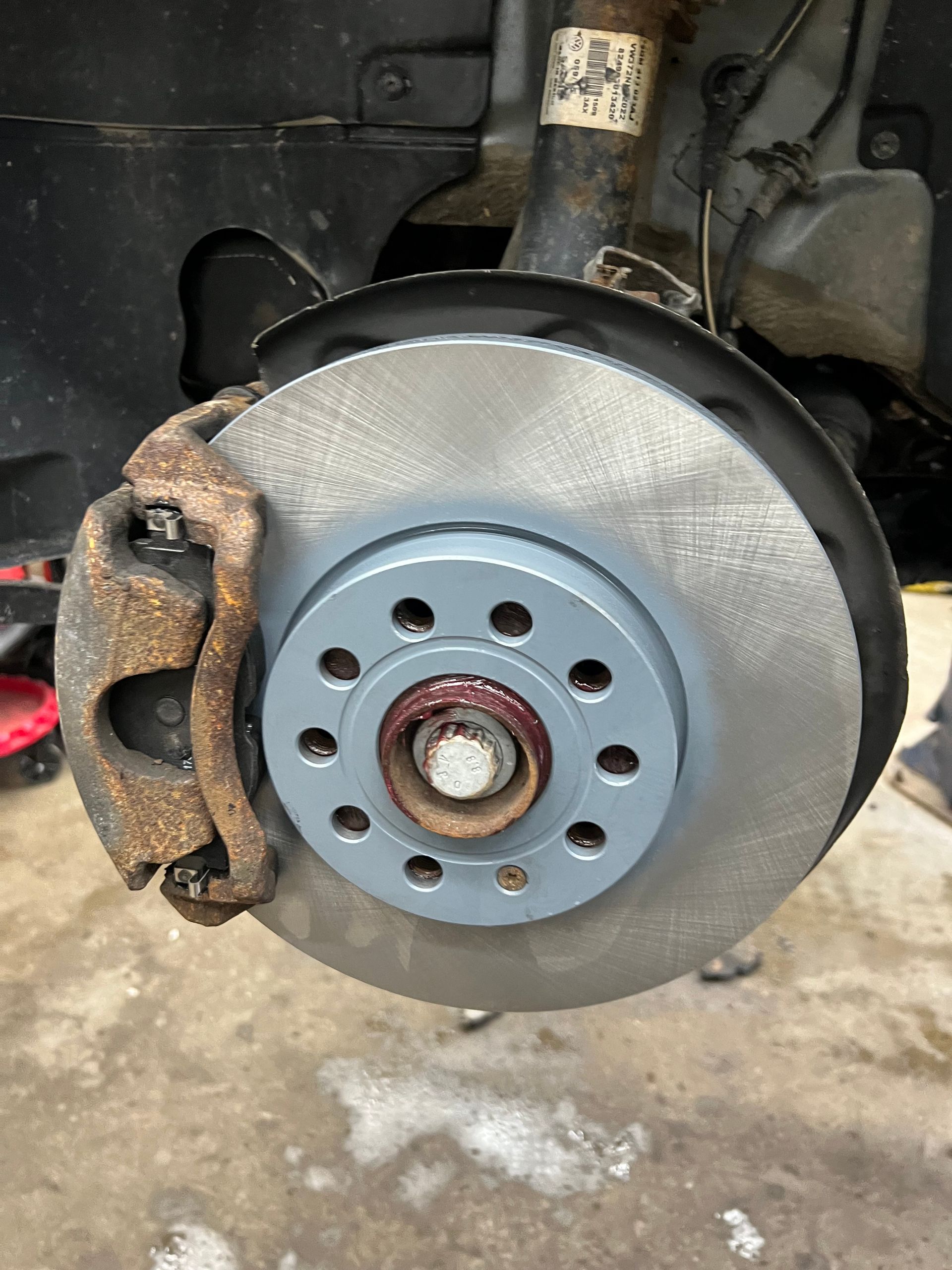 A close up of a brake disc on a car.