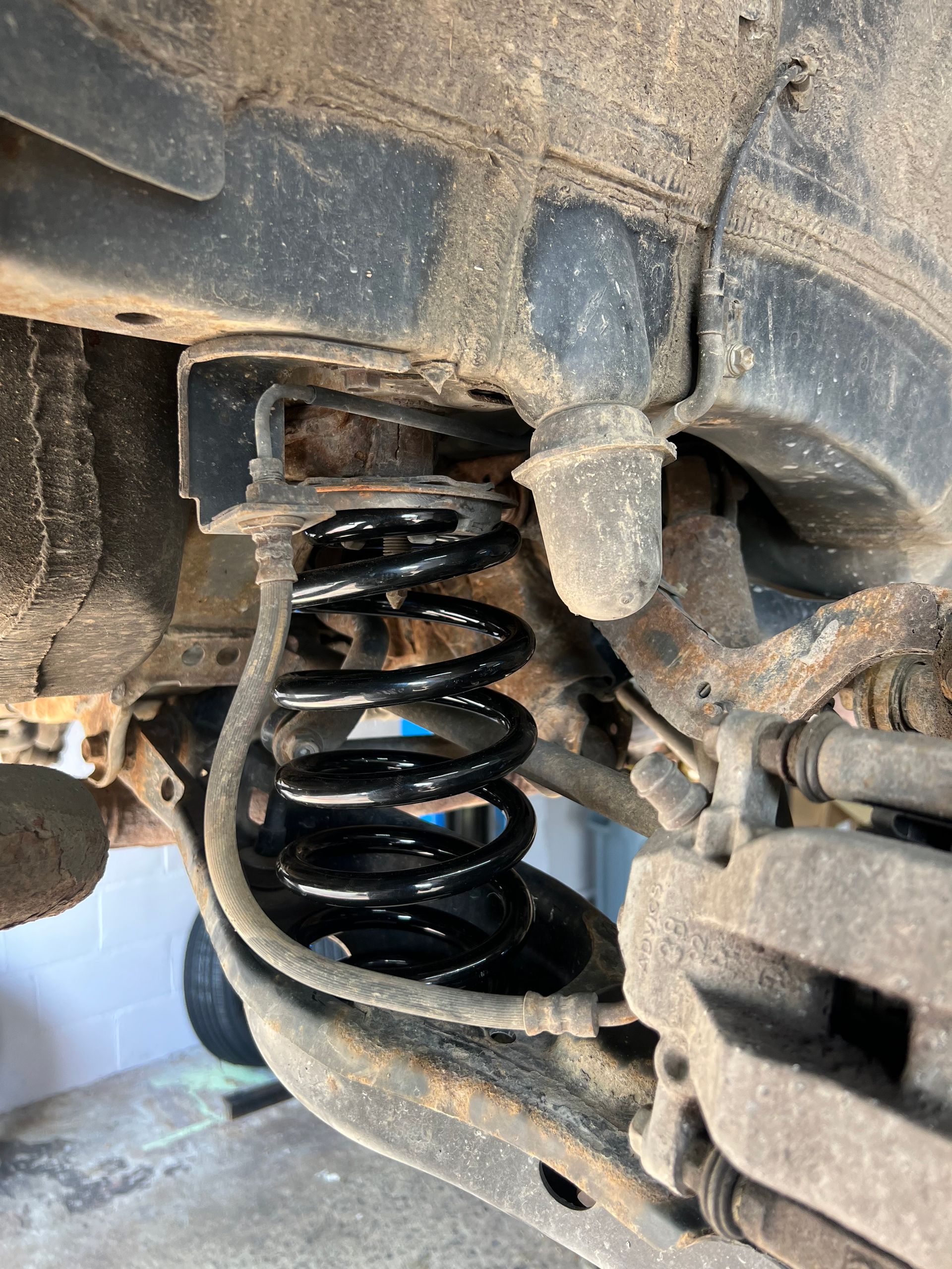 A close up of a shock absorber on a car.