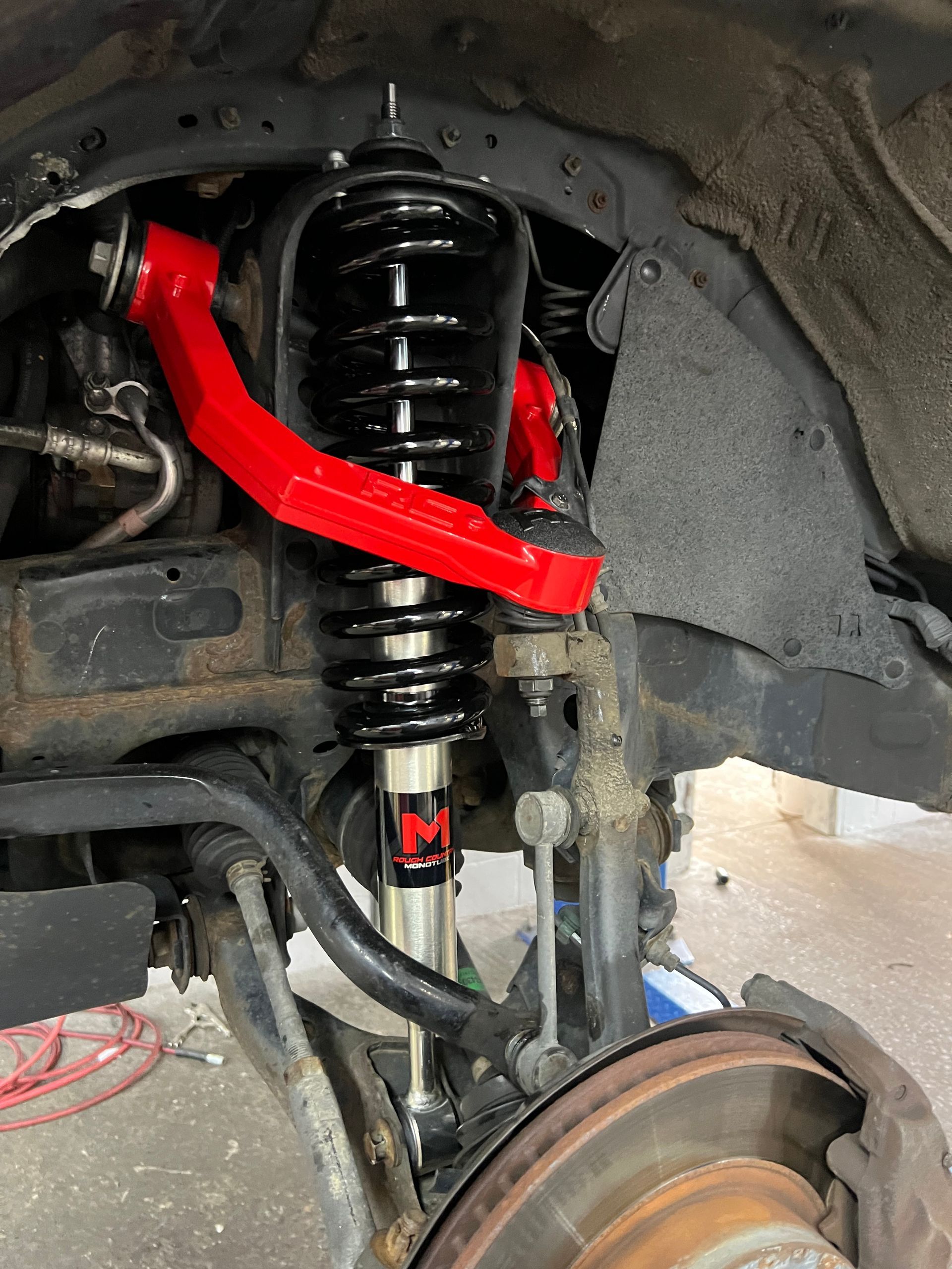 A close up of a suspension system on a truck.