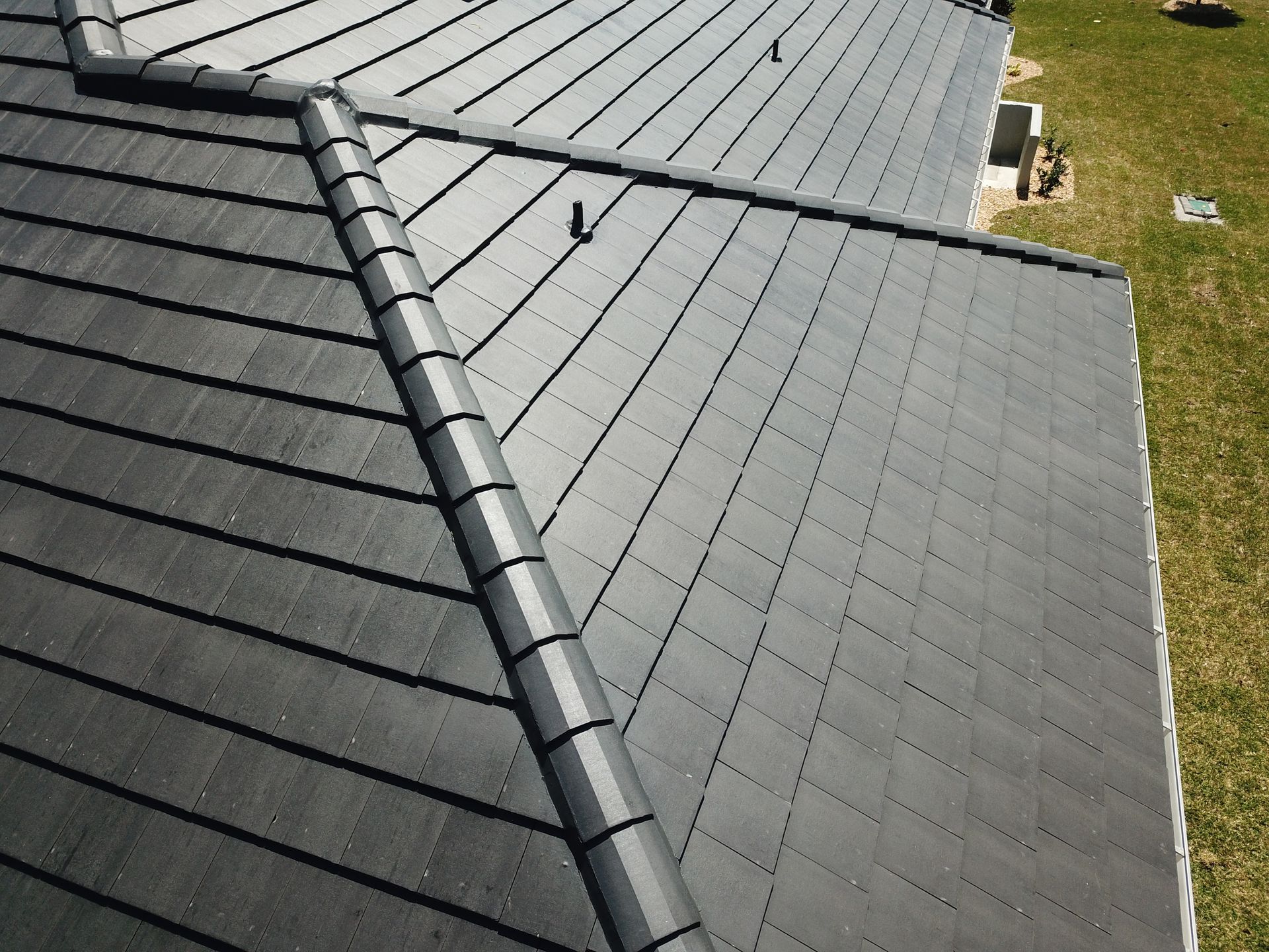 Gray metal roof with ridge vent and skylight, viewed from above