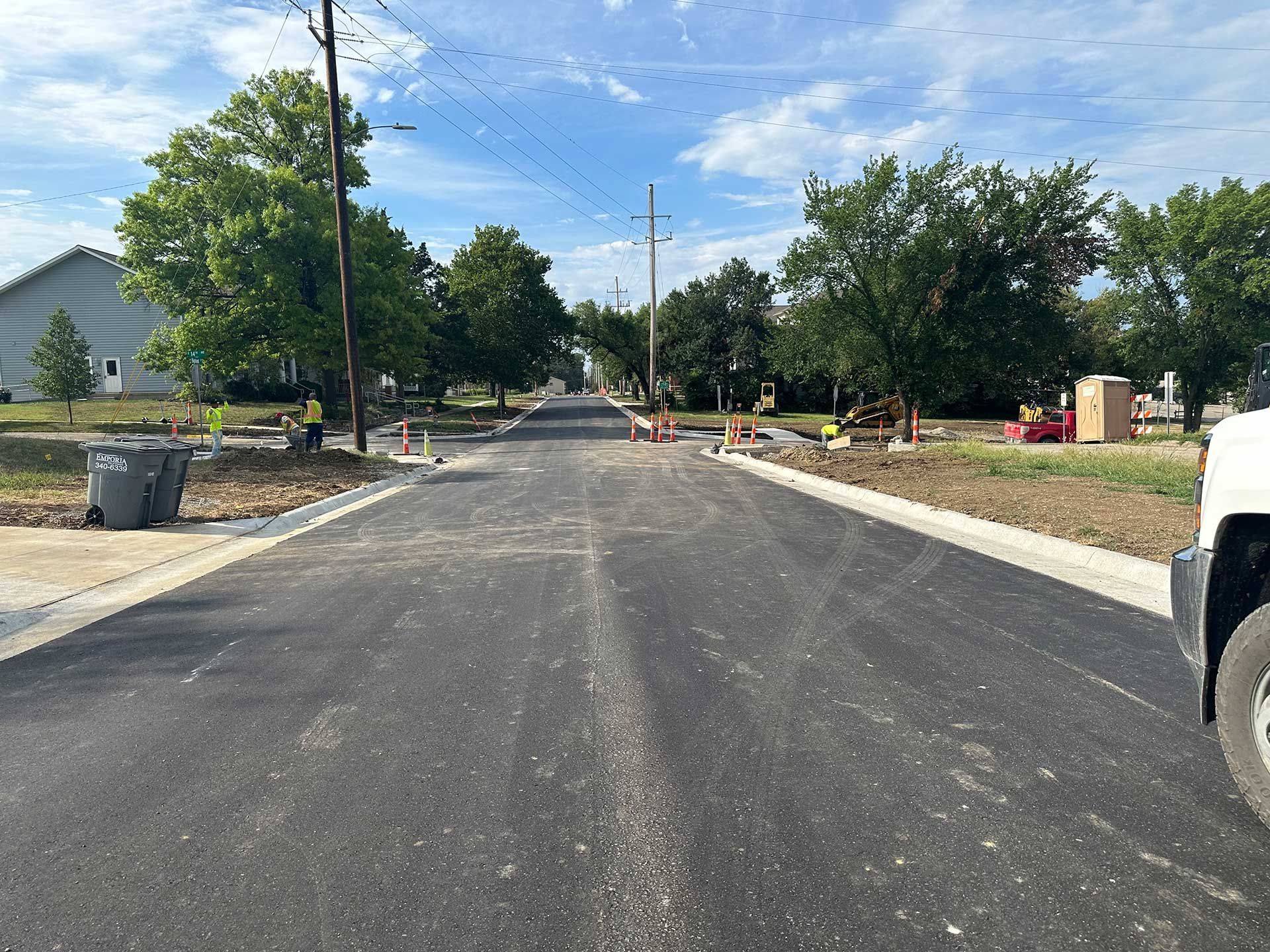 a truck is parked on the side of a concrete road