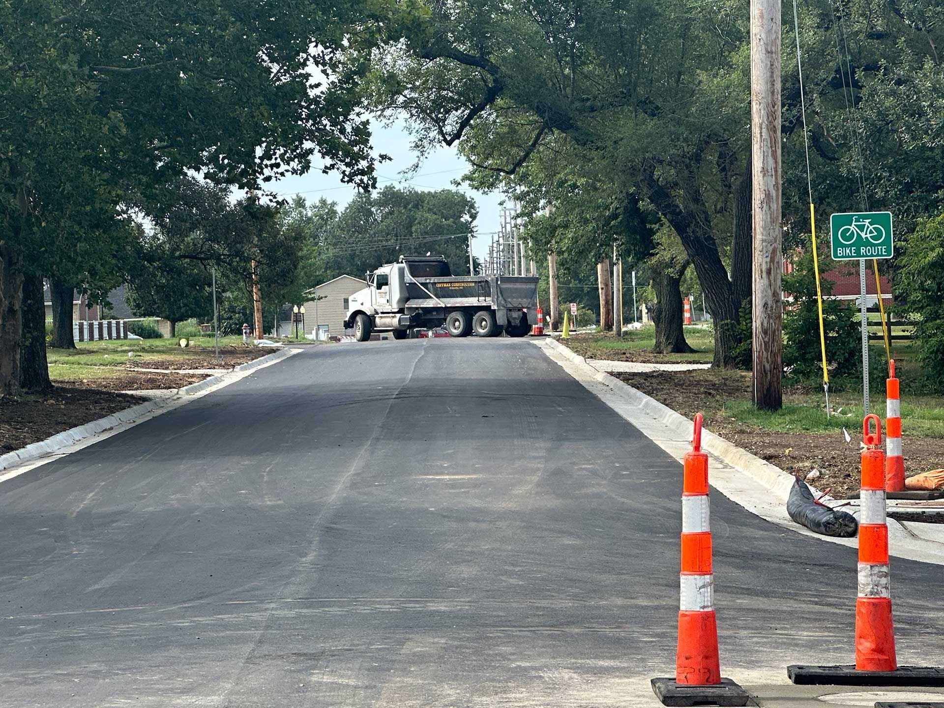 a truck is driving down a concrete road