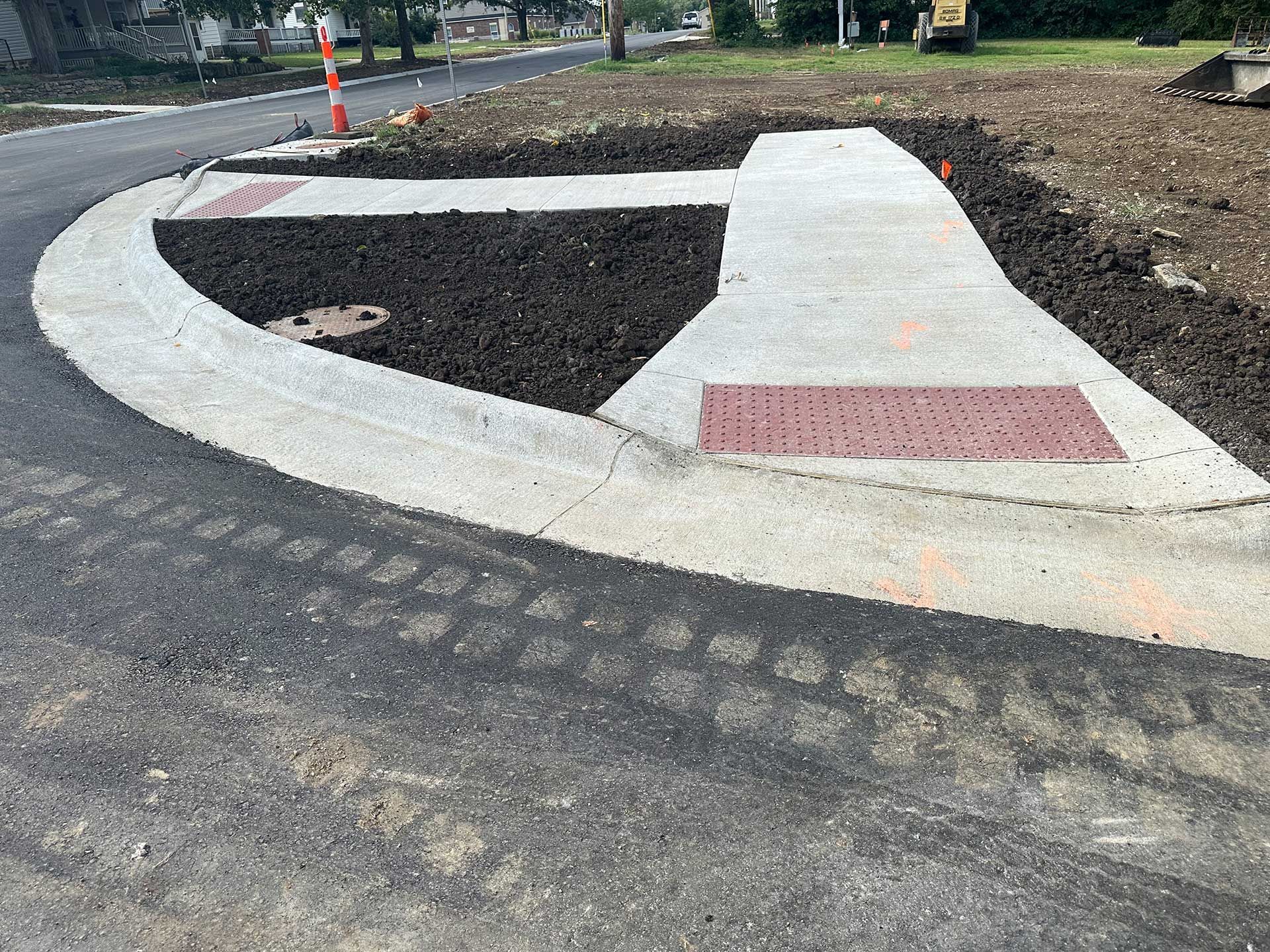 a concrete walkway is being built on the side of a road