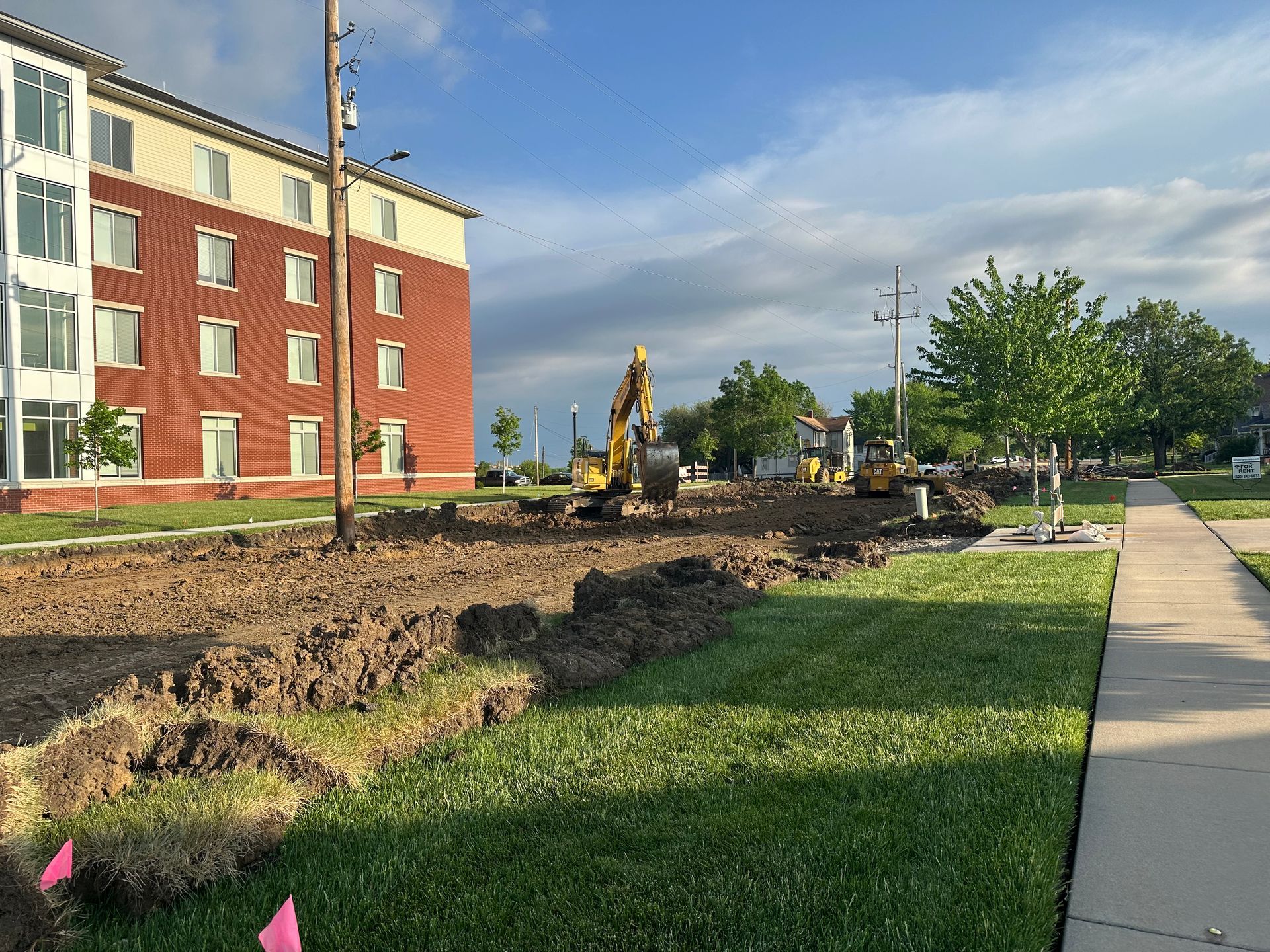 a construction site with a large brick building in the background