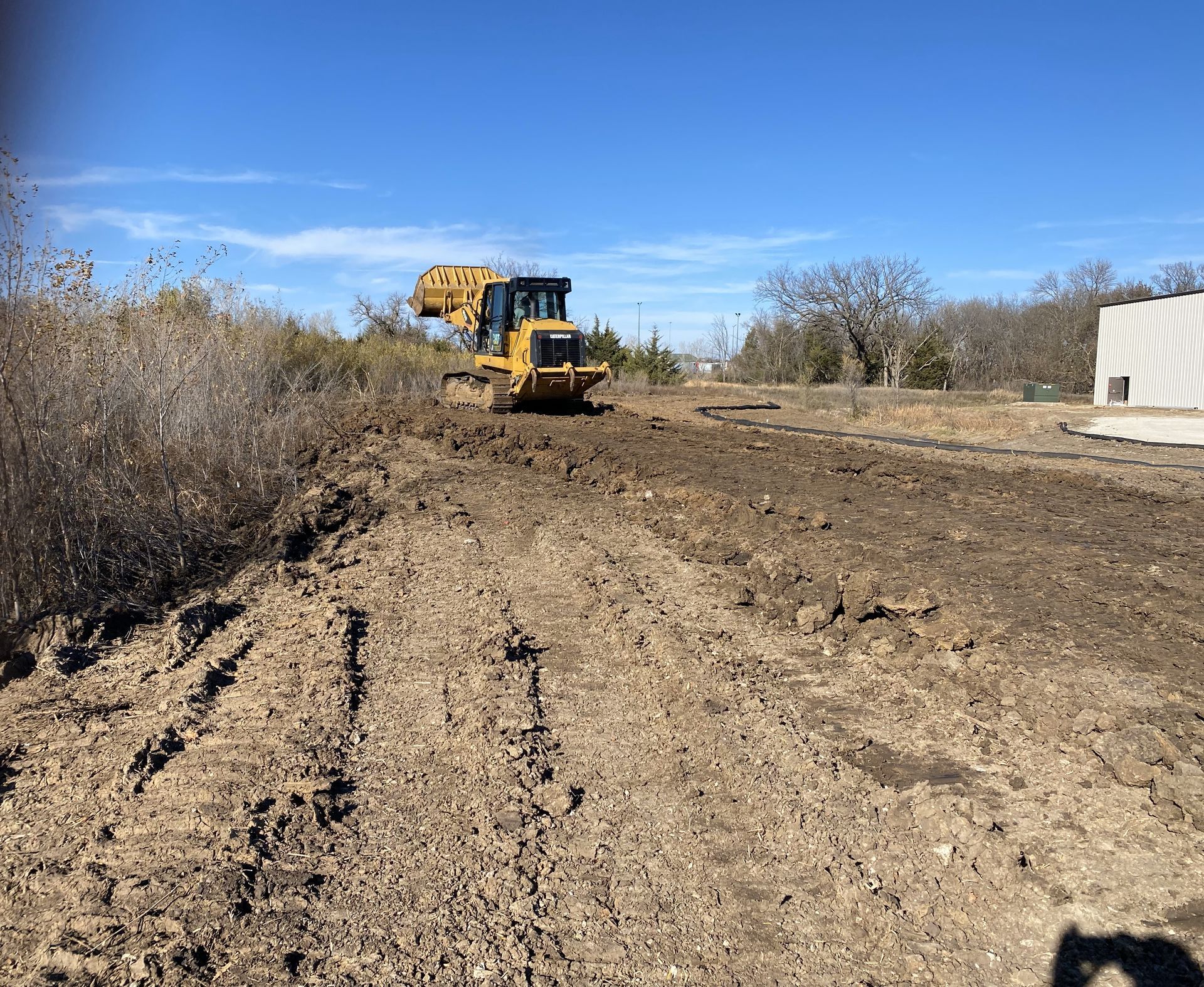 a bulldozer is driving through a dirt field
