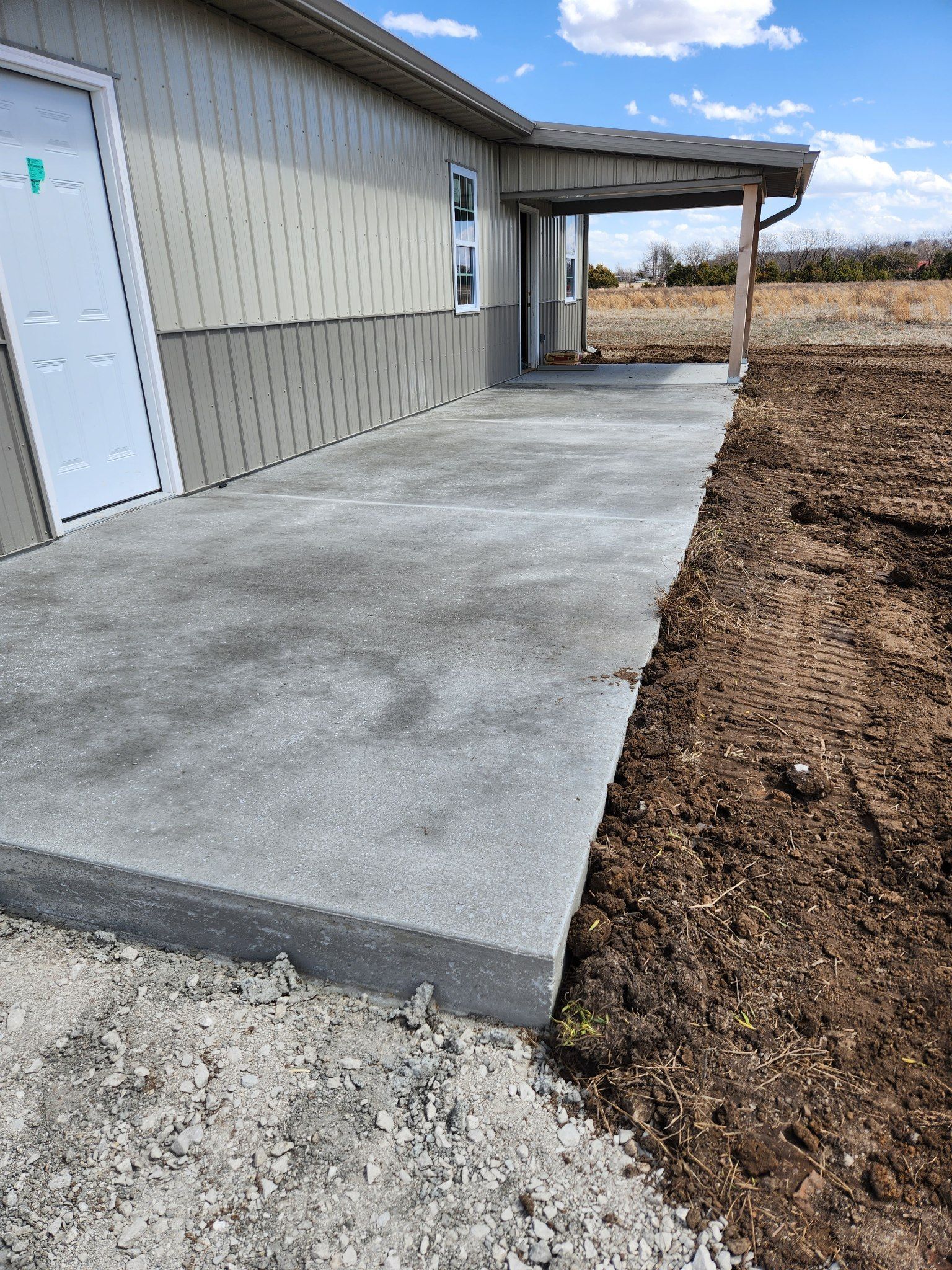 a concrete walkway is being built in front of a house