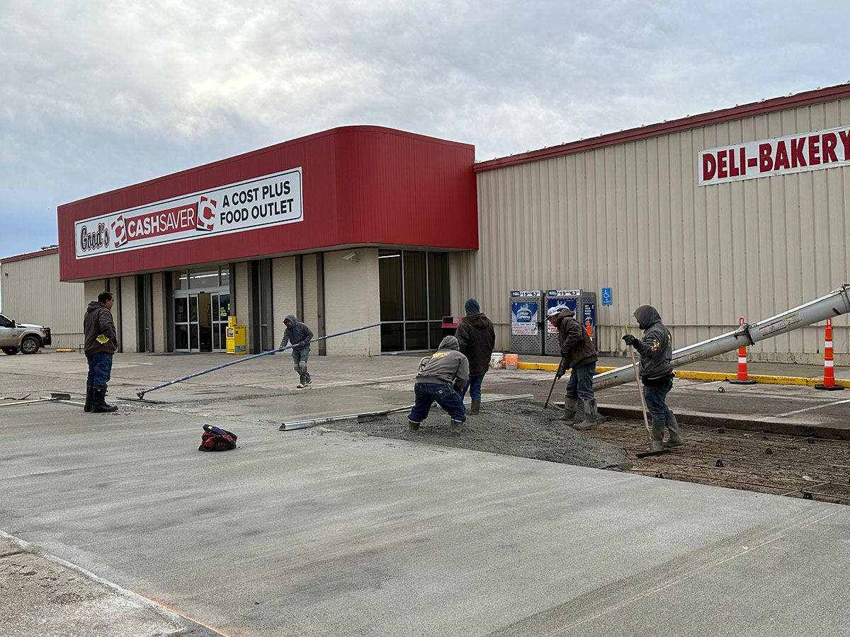 The SR Coffman Construction Inc. team working on a concrete driveway in front of a commercial building
