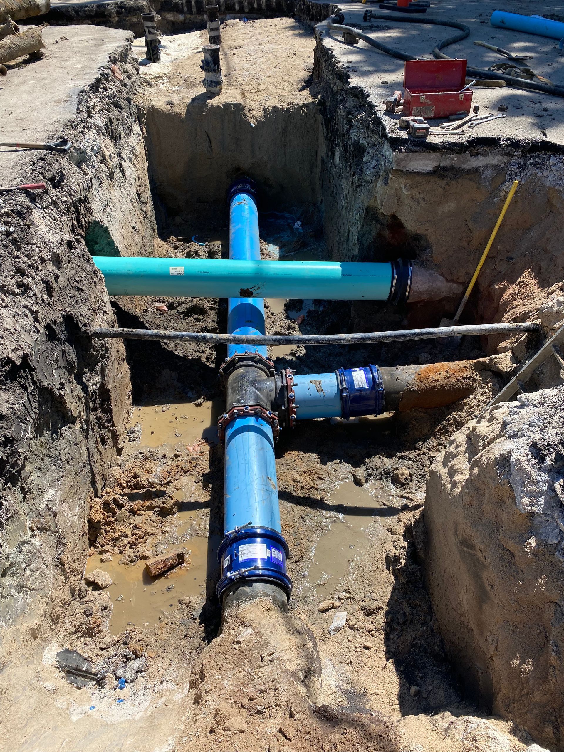 a bunch of pipes are being installed in a hole in the ground