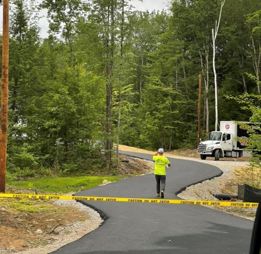 A man in a yellow shirt is running down a road
