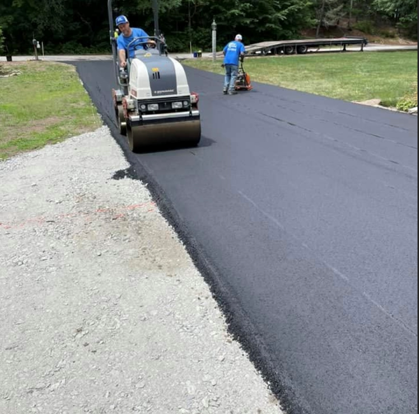 A man is driving a roller on a road