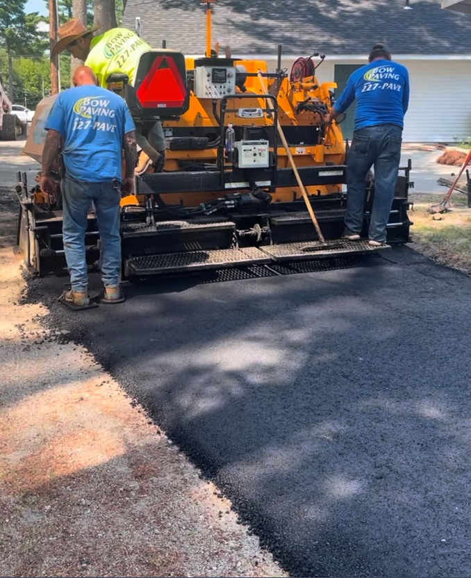 Two men wearing blue shirts with the word asphalt on them