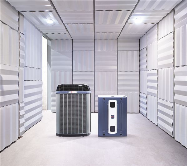 An air conditioner and a device in a soundproof room with textured white walls.