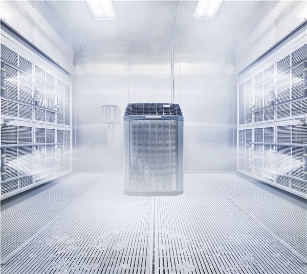 Washing machine inside a paint booth. Stainless steel interior, grated floor.