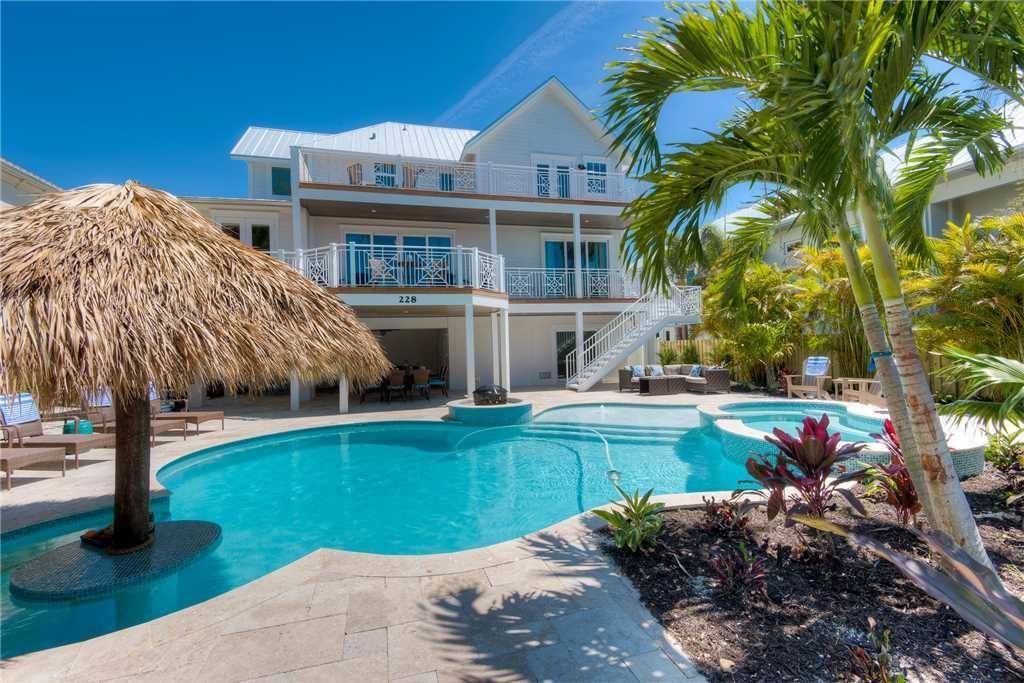 A large house with a large swimming pool in front of it.