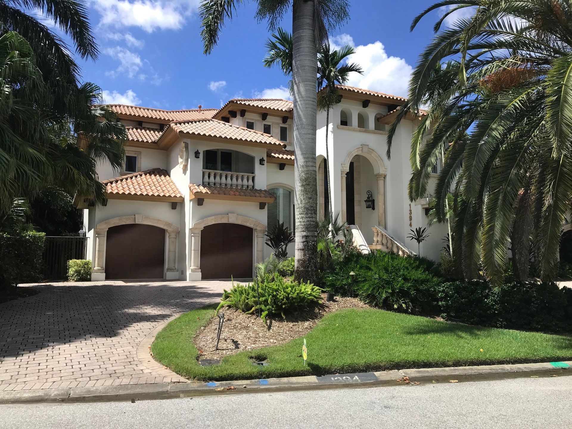A large house with a palm tree in front of it