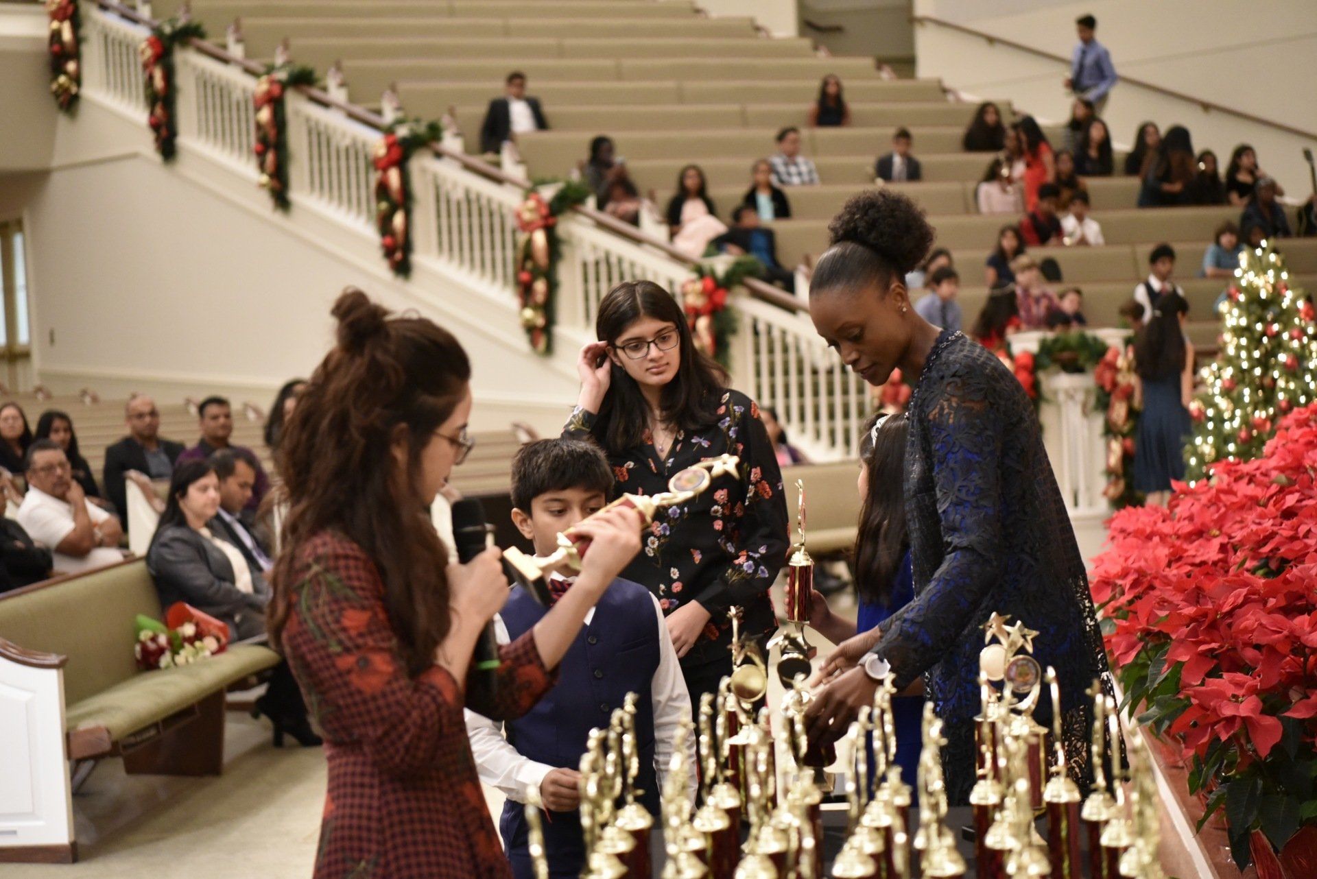 People awarding trophies at an event. 