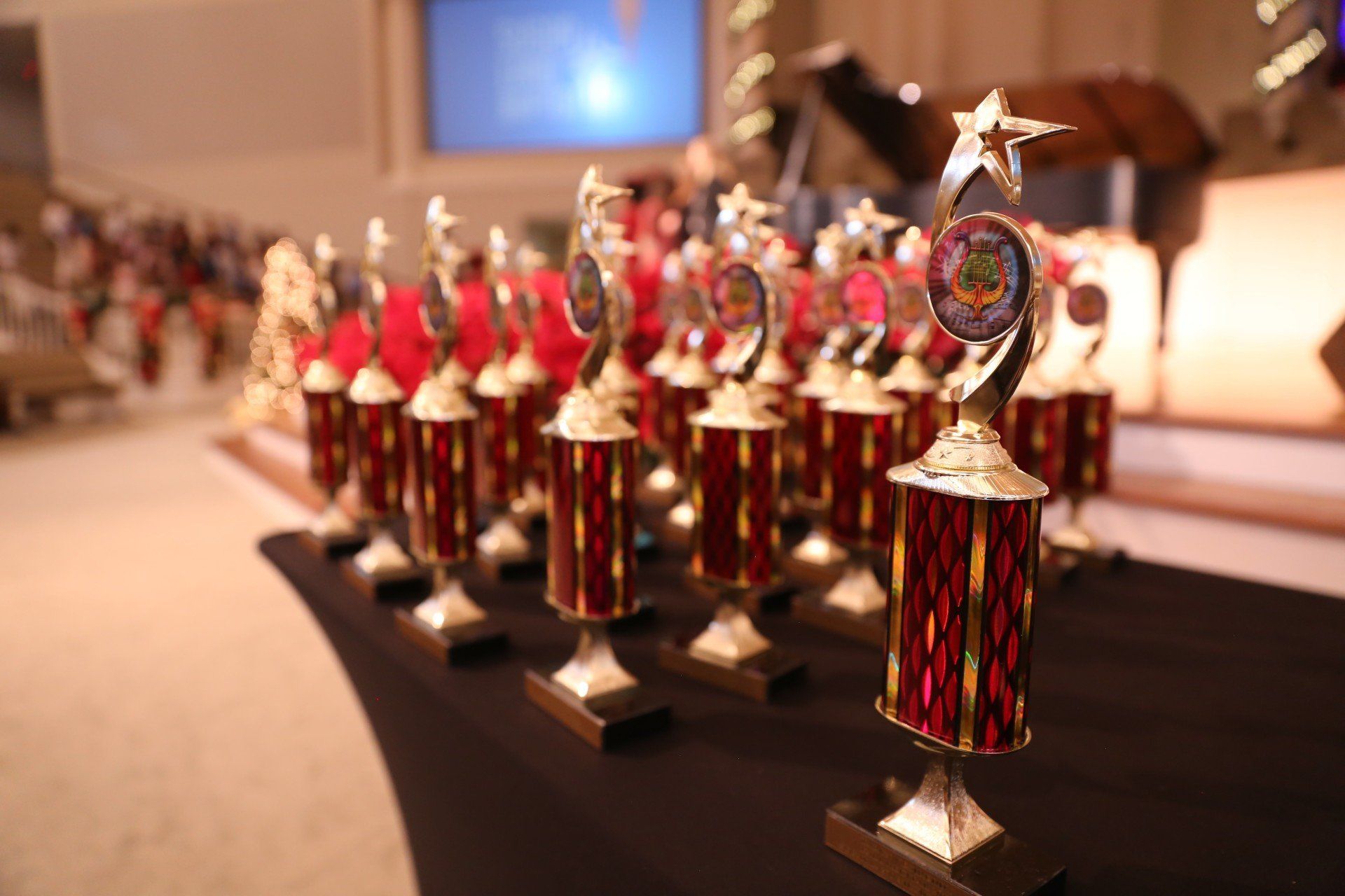 Trophies lined up on a table, awaiting awards ceremony.